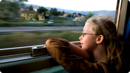 Girl looking out of a moving train